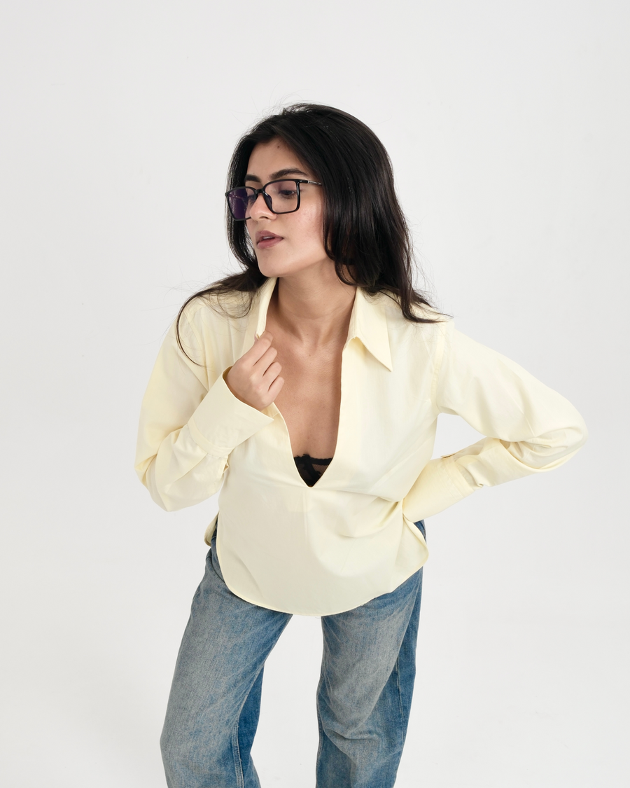 POPOVER SHIRT butter yellow relaxed fit poplin shirt showing open V neckline – three-quarter view – YUMIS