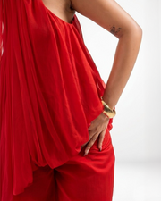 Close-up of WHISPER red chiffon jumpsuit showing gathered halter neck and drape detail – YUMIS
